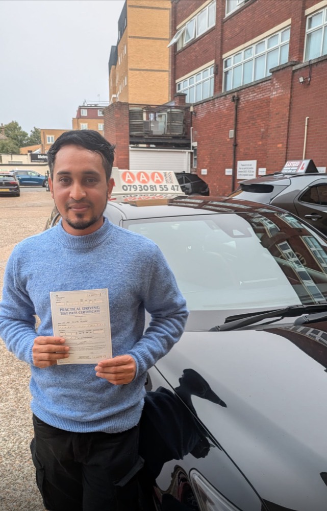 Smiling Auto Pass student holding his driving test pass certificate
