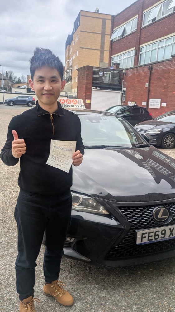 Auto Pass student with his pass certificate beside the tuition car